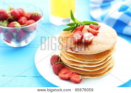 Tasty Pancakes With Strawberry On Blue Wooden Background