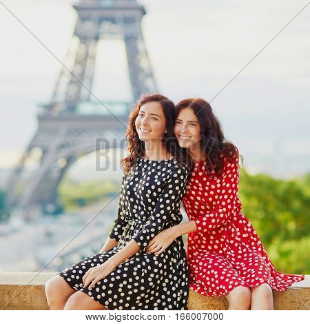 Twin Sisters In Front Of The Eiffel Tower In Paris, France