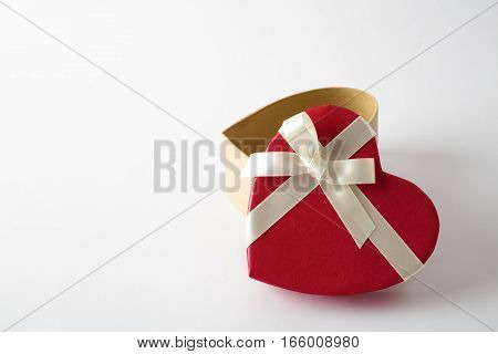 Gift box on the white background. Red ribbon. Valentines Day gift. Isolated