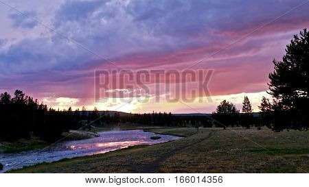 Sunset over steaming Firehole river. Midway Geyser Basin. Yellowstone National Park. Jackson Hole. Wyoming. United States.