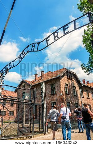 AUSCHWITZ-BIRKENAU CONCENTRATION CAMP, KRAKOW, POLAND - CIRCA JUNE 2012: View of entrance of the camp with famous inscription Arbeit Mach Frei