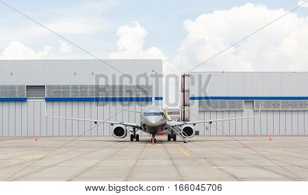 passenger business aircraft on a background of a hangar