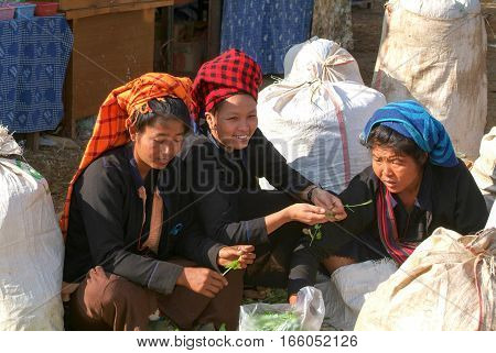 Indein Myanmar - 15 January 2010: people on traditional clothes at the weekly market at Indein on Inle Lake in Myanmar