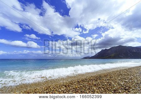 Beautiful sea paradise beach on a background of blue sky with clouds.