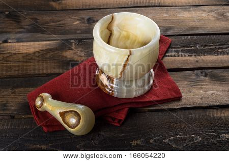 onyx Mortar and Pestle on a wooden Background