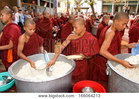 Mandalay Myanmar 17 January 2010: Monks in a row at Mahagandayon Monastery. Monks are venerated members of Burmese society. In these image they are going to lunch.