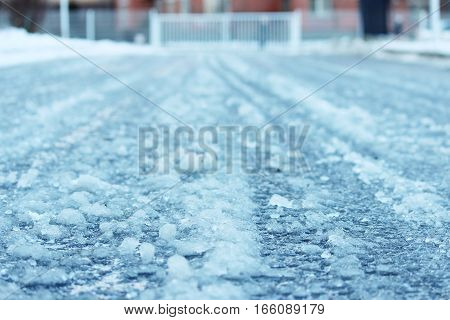 road after thaw and frost covered with slippery ice icy