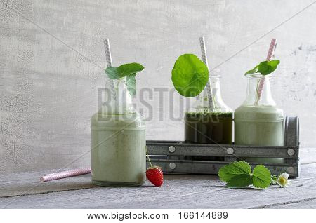fresh tasty  green smoothie with indian cress leaves and garden strawberries