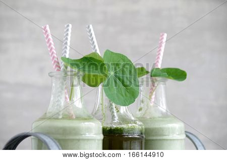 fresh tasty  green smoothie with indian cress leaves and garden strawberries