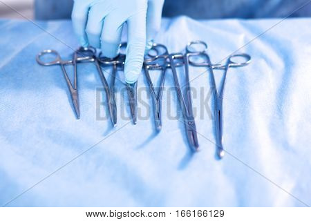 surgical Instruments on green or blue background.