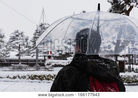 Close up of traveller waitng to cross the road in winter takayama Giu Japan.