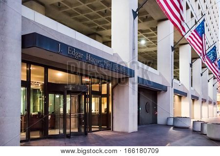 Washington DC, USA - December 29, 2016: FBI Federal Bureau of Investigation Headquarters on Pennsylvania avenue sign with American flags