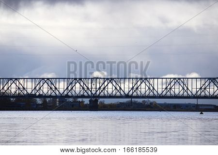 white cumulus clouds pass bridge over the Northern Dvina River