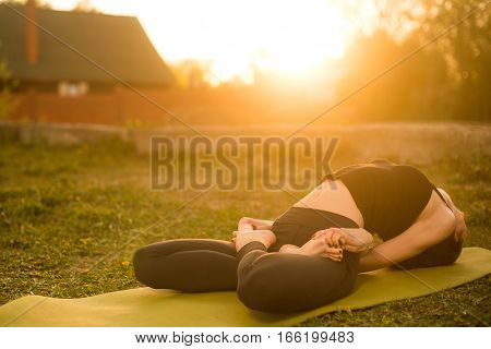 woman practicing outdoors meditating in yoga position