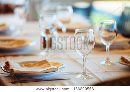 The cozy interior of summer cafe - sheltered tables with white tablecloths