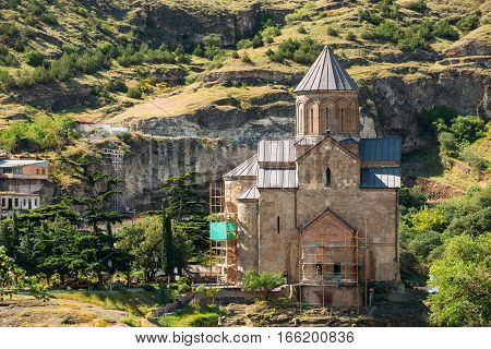 The Metekhi Church In Tbilisi, Georgia. Metekhi is a historic neighborhood of Tbilisi, Georgia, located on the elevated cliff that overlooks the Mtkvari river.