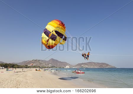 KHORFAKKAN UAE - DEC 1 2016: Parasailing on the beach in Khorfakkan Emirate of Sharjah United Arab Emirates