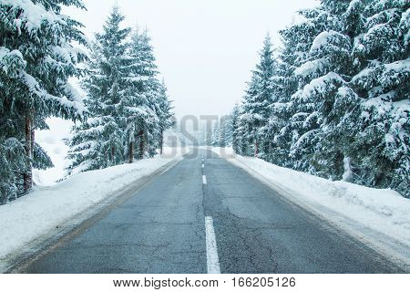 Empty road in winter landscape in Lika, Croatia