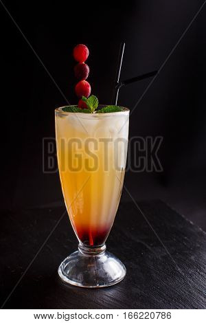 Pina colada drink cocktail glass isolated on black background