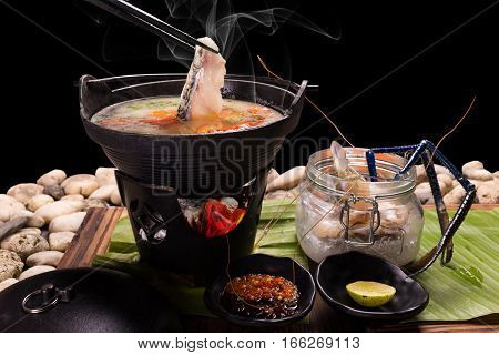 Food served in a pot Japan where the sea food shabu-shabu of the sea bream is hot on black background