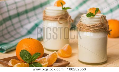 Fresh Organig Natural White Yogurt In Glass Jars With Tangerine And Mint