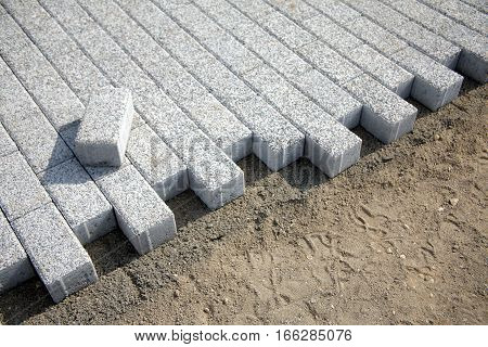 Laying paving slabs of gray in the town's pedestrian zone horizontal photo diagonal view