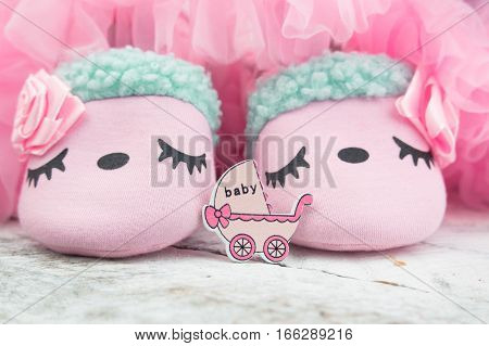 Little girlie baby shoes on a wood