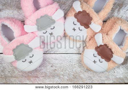 Little girlie baby shoes on a wood