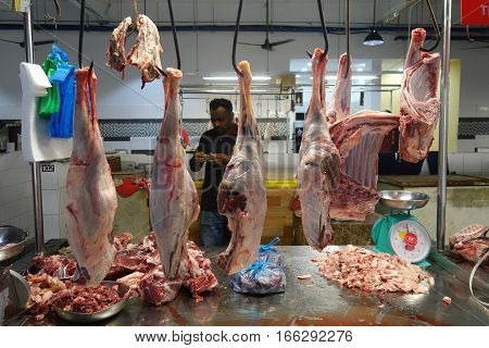 Unidentified Indian Butcher Sits At His Butcher Shop