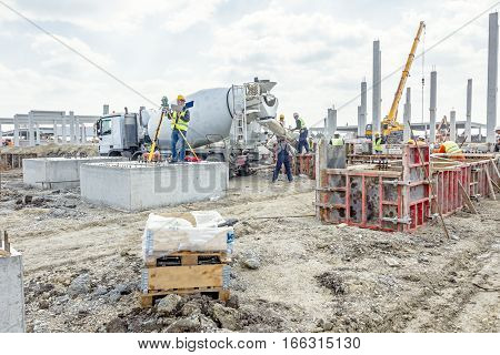 Zrenjanin Vojvodina Serbia - May 25 2015: Surveyor engineer is measuring level on construction site. Surveyors ensure precise measurements before undertaking large construction projects.