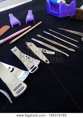 Tools for manicure on a black background accessories in the beauty salon.