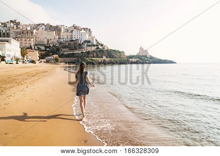 Young Girl Running On The Beach Of Sperlonga, Italy