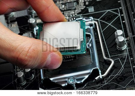 Plug in CPU microprocessor to motherboard socket. Technological background.Concept computers harware