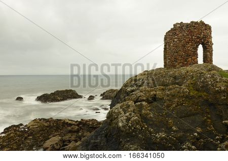 A view of an old stone tower on the headland at Elie