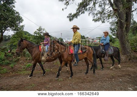 May 22 2016 Florencia Costa Rica: local tico farmers riding their horses to a harvest day celebration event