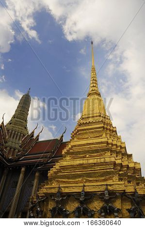 view of famous religion temple wat phra prakaew grand palace in Bangkok Thailand under a blue sky in travel and tourist destination landmark in Asia