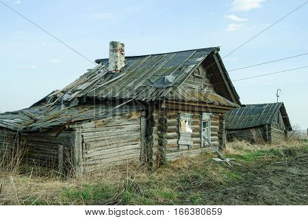 Wooden abandoned old house with the driven-in windows in Preobrazhenskoe. Tyumen region. Russia