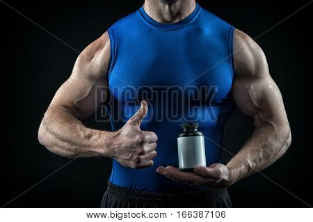 Handsome Sexy Athlete Man With Muscular Body Holds Steroid Jar