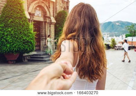 Woman Discovering An Ancient Temple Holding Boyfriend's Hand.