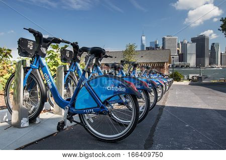 New York, August 19, 2016: A Citibike station on Governor's Island with downtown Manhattan seen in the background.