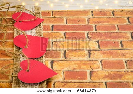 Valentine hearts interwoven with hemp twine on lace natural ribbon and bricks with room for copy