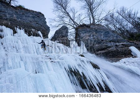Ice climbing on frozen waterfall Pericnik in Slovenia