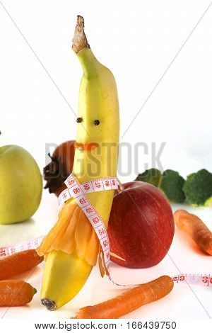 Measuring tape wrapped around a banana isolated on a white background, Concept of diet.