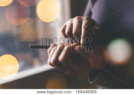 Woman using digital tablet computer for internet browsing young adult female standing by the window