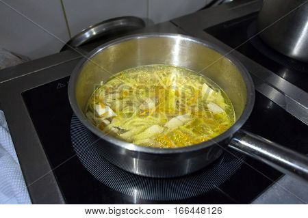 Close-up of preparing noodle soup on oven