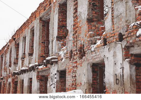 Old Building Falling Apart With Broken Windows, Walls Covered With Cracks And Scratches