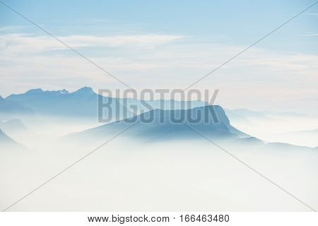 beautiful french alps winter panoramic aerial view landscape with a fantastic blue haze cloudy mountain background