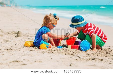 kids play with sand on summer beach, family beach vacation