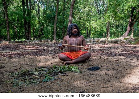 DABANA, SRI LANKA - CIRCA DECEMBER 2016: Vedda man holding axe. Veddas are an indigenous people of Sri Lanka living in tribes in the jungle