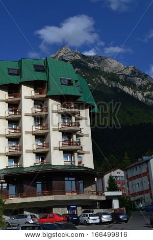 Tourist resort Busteni at the foot of the mountains. 
You can see the villas, the Bucegi mountains and forest